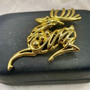 Vintage AM Lee Leaping Reindeer Brooch Pin with a Filigree Design. Gold Tone
